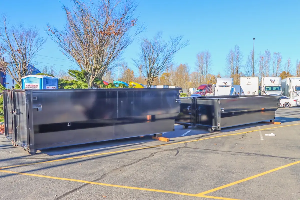 Professional dumpster rental service with roll-off container on residential driveway in Chartiers